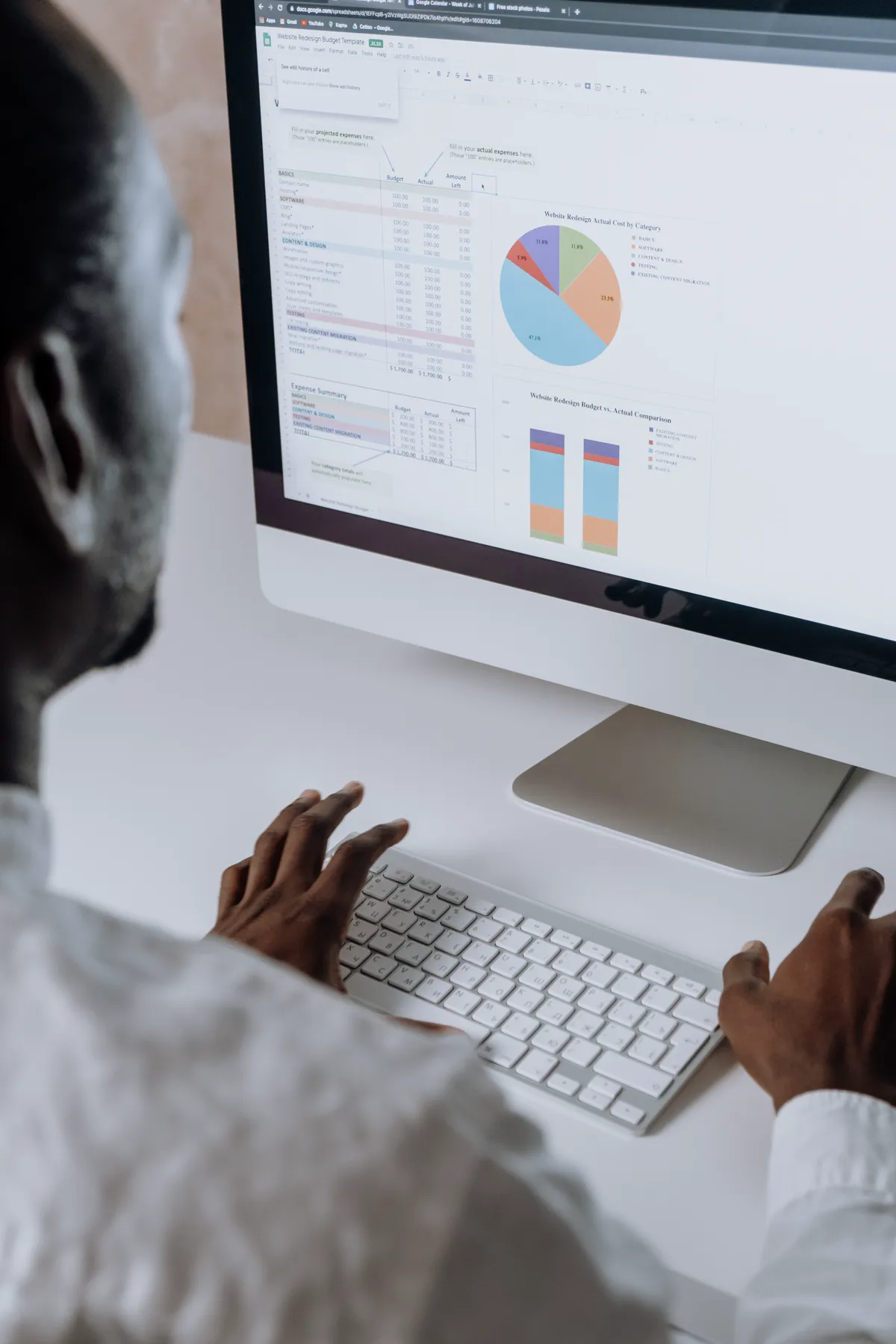 Mitarbeiter arbeitet an einem Bildschirm mit Tabellen und Auswertungen in einer ERP-Software
